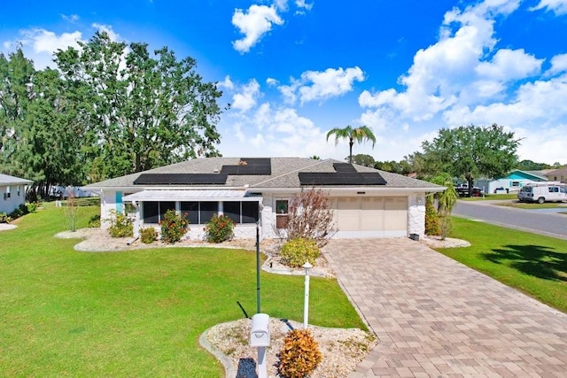 prairie-style house with solar panels, a garage, and a front lawn