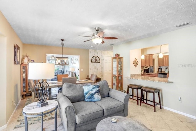 tiled living room with ceiling fan