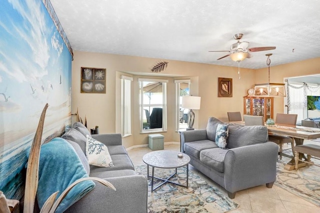 living room with light tile patterned flooring, a textured ceiling, and ceiling fan