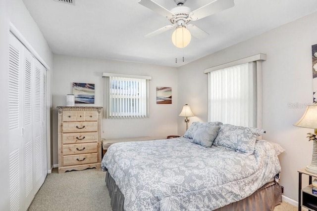 carpeted bedroom with a closet and ceiling fan