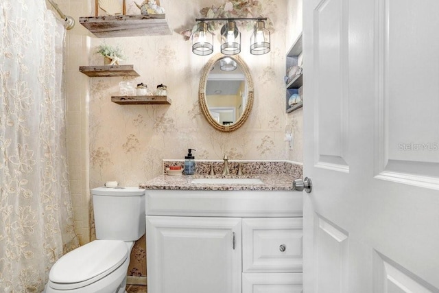 bathroom featuring vanity, a shower with shower curtain, and toilet