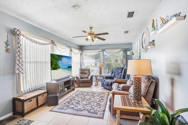 sitting room with light tile patterned floors and ceiling fan