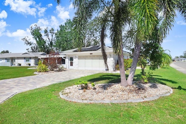 ranch-style house featuring a front yard and a garage