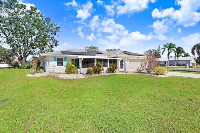 ranch-style house with a front yard and solar panels