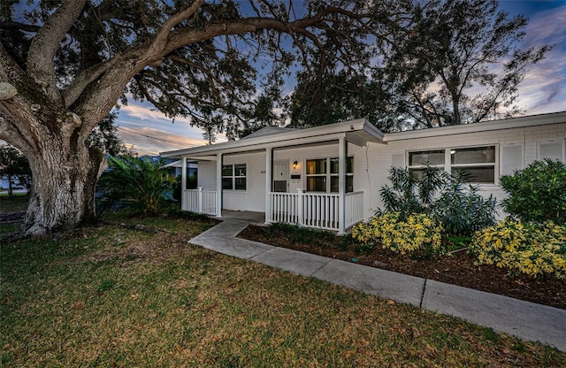 view of front of home featuring a yard and a porch