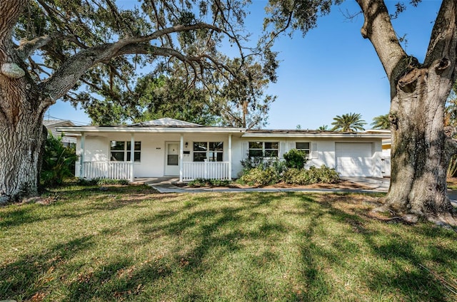 single story home featuring a garage, a front lawn, and covered porch