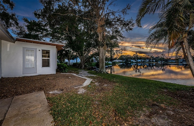 yard at dusk with a water view