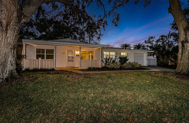 ranch-style home with a yard and a porch