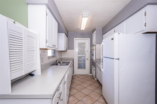 kitchen featuring sink, light tile patterned flooring, white cabinets, white appliances, and tasteful backsplash