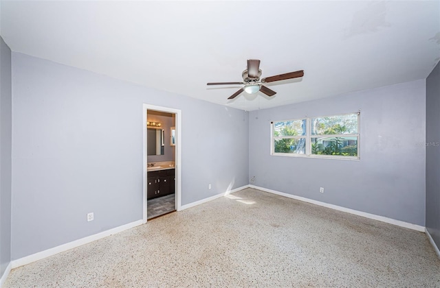 unfurnished bedroom featuring ceiling fan and ensuite bathroom