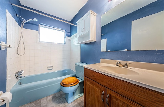 full bathroom featuring vanity, toilet, and tiled shower / bath