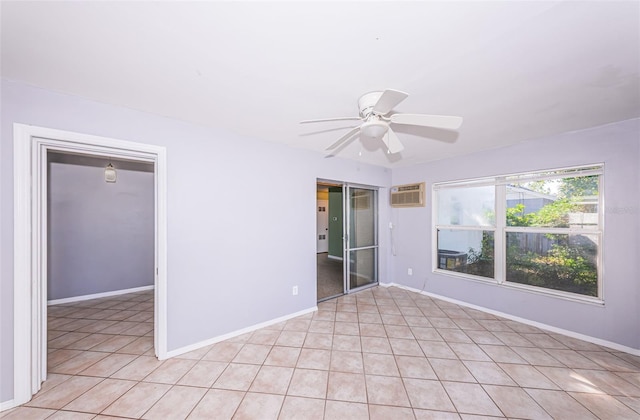 empty room featuring ceiling fan and a wall mounted air conditioner