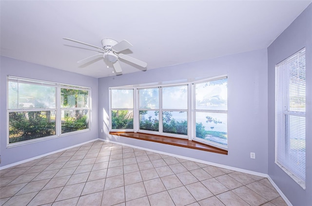 unfurnished sunroom featuring ceiling fan