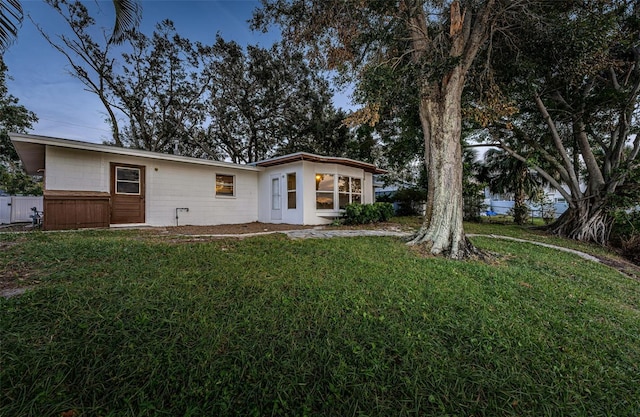 rear view of house with a yard