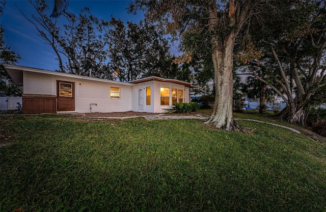 rear view of house featuring a yard