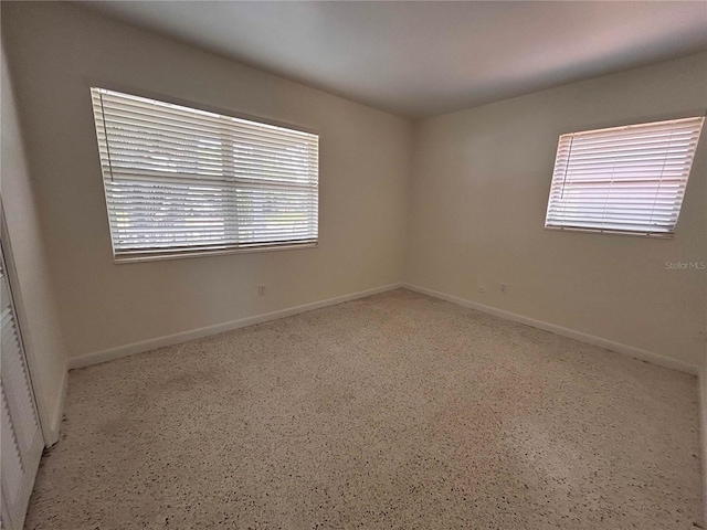 empty room with baseboards and a wealth of natural light