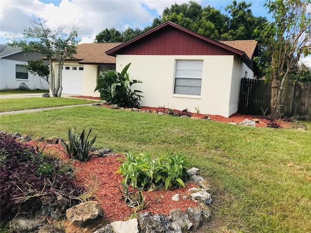 view of front of home with a garage and a front lawn