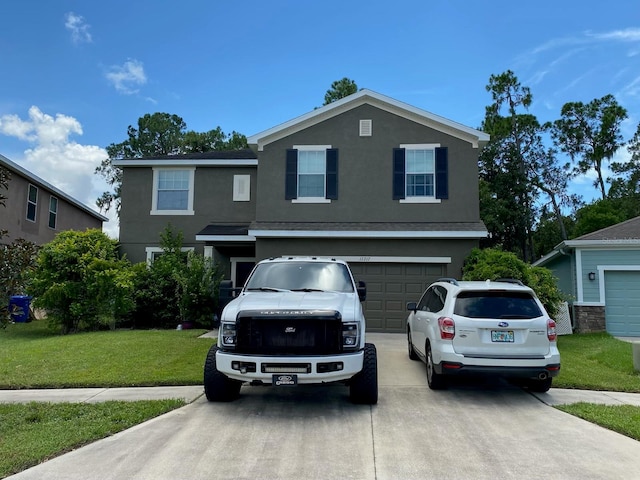 view of front of home featuring a front lawn and a garage