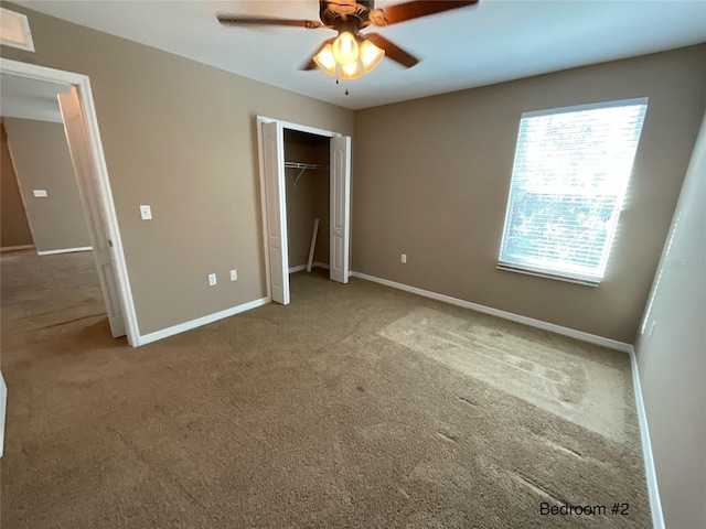 unfurnished bedroom featuring carpet flooring, a closet, and ceiling fan