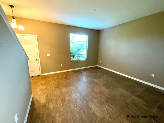 empty room featuring an inviting chandelier