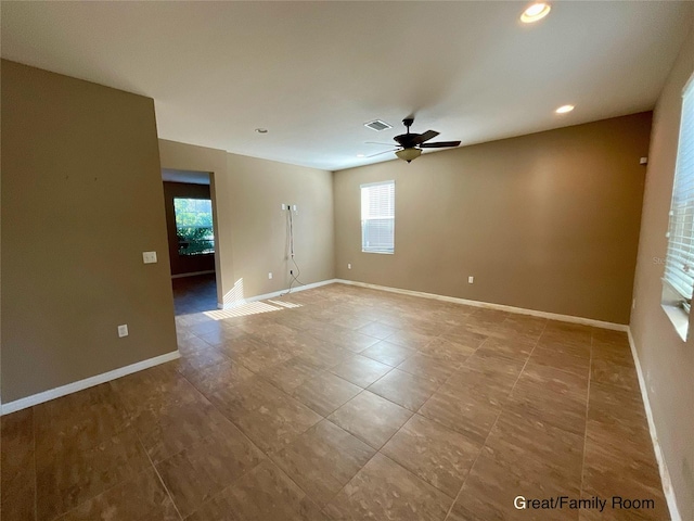 empty room featuring ceiling fan and a healthy amount of sunlight