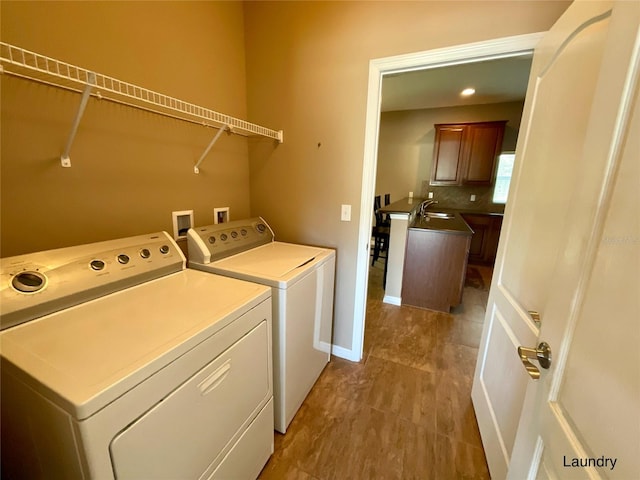 washroom featuring washing machine and dryer and sink