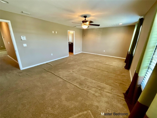 carpeted spare room featuring ceiling fan