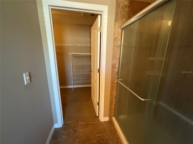 hall with dark tile patterned flooring