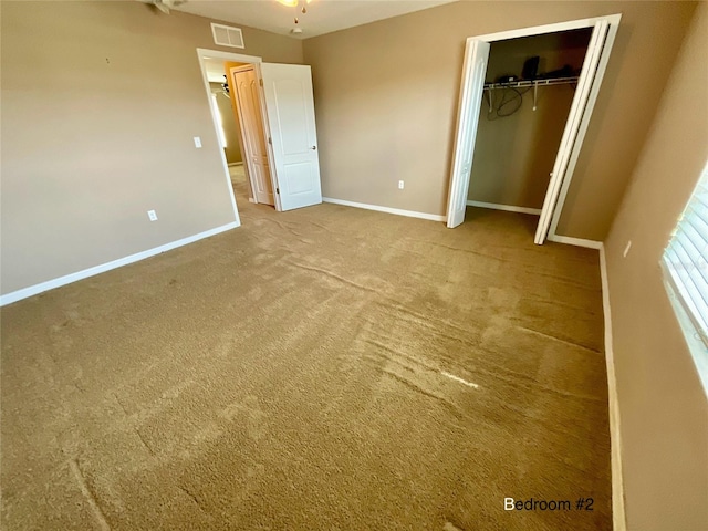 unfurnished bedroom with a closet and carpet