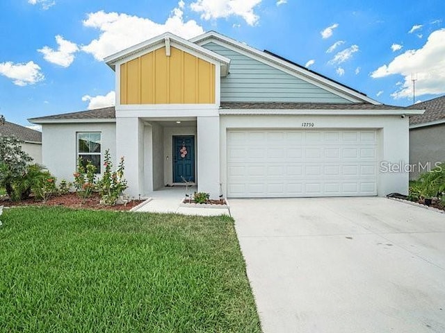 view of front facade with a front lawn and a garage