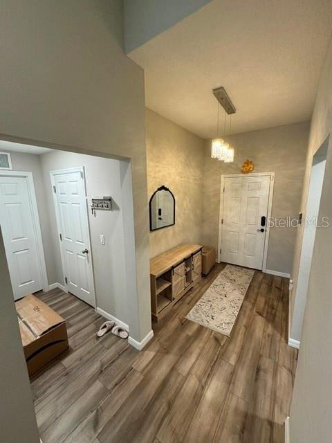 foyer entrance featuring an inviting chandelier and hardwood / wood-style flooring