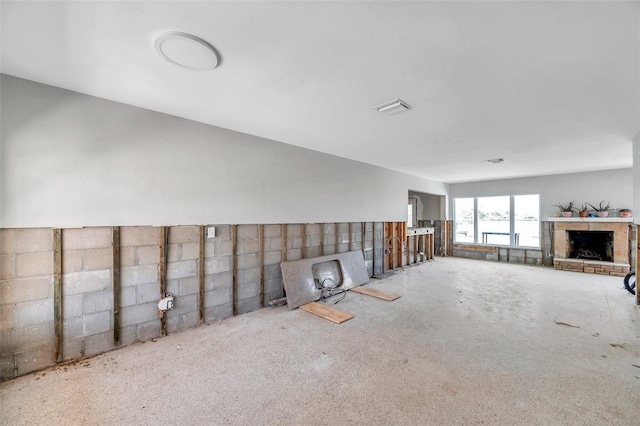 unfurnished living room with a brick fireplace