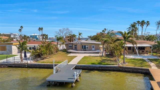 view of dock with a water view and a yard