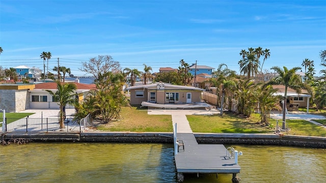 back of property featuring a patio, a water view, and a yard