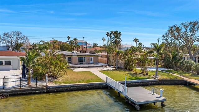 view of dock featuring a yard, a patio area, and a water view