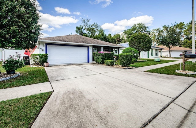 ranch-style house with a front lawn and a garage