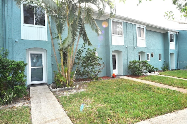 117 114th Ave N Unit 117, Saint Petersburg, FL 33716 - view of front facade with stucco siding and a front yard