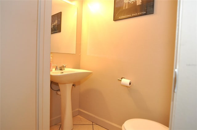 bathroom featuring sink, toilet, and tile patterned flooring