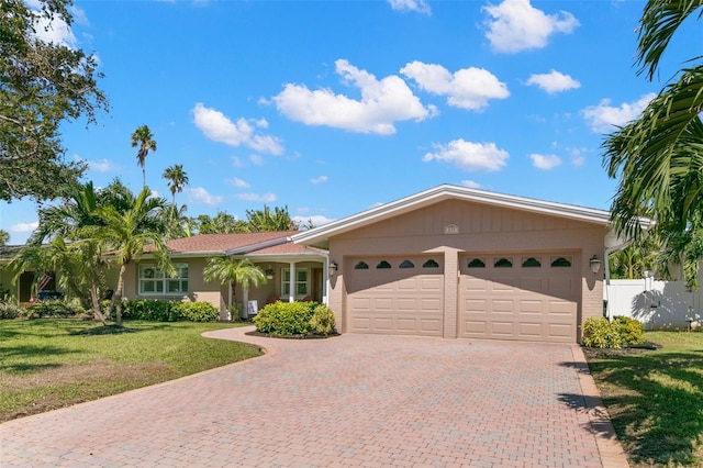 ranch-style home with a front yard and a garage