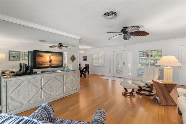 living room with light hardwood / wood-style floors and ornamental molding