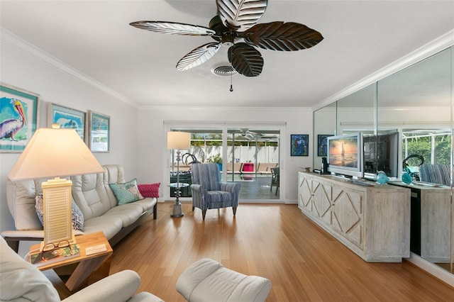 living room with light hardwood / wood-style floors, ceiling fan, and ornamental molding