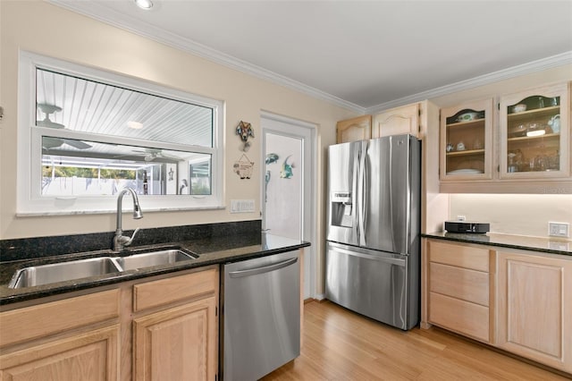 kitchen with sink, light hardwood / wood-style flooring, crown molding, light brown cabinetry, and appliances with stainless steel finishes