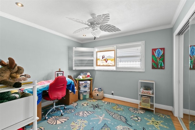 interior space featuring ceiling fan, hardwood / wood-style flooring, and ornamental molding