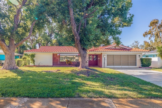 view of front of home with a front yard and a garage