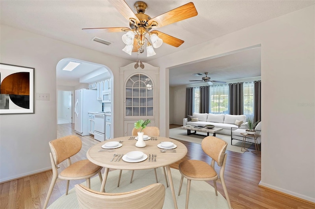 dining area featuring light hardwood / wood-style floors and ceiling fan