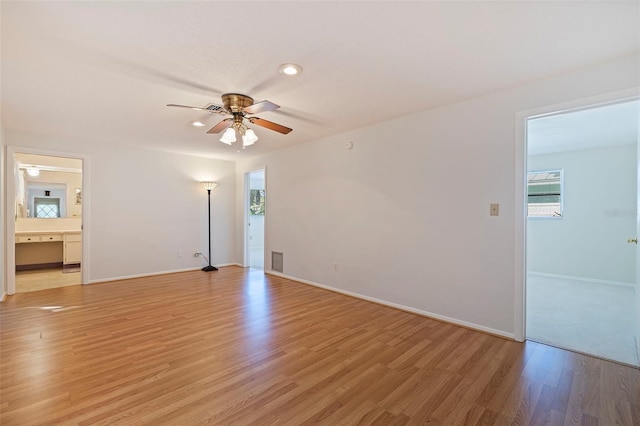 spare room with light wood-type flooring and ceiling fan