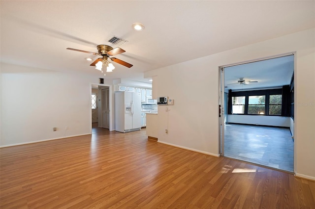 unfurnished living room with light hardwood / wood-style floors and ceiling fan