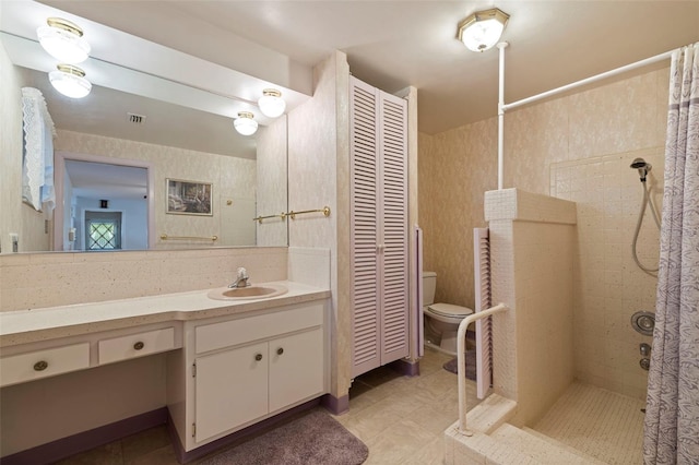 bathroom featuring toilet, a shower with curtain, vanity, and tile patterned flooring