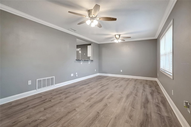 empty room featuring ceiling fan, hardwood / wood-style floors, and ornamental molding