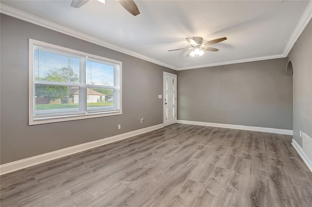 empty room featuring hardwood / wood-style floors, ceiling fan, and crown molding